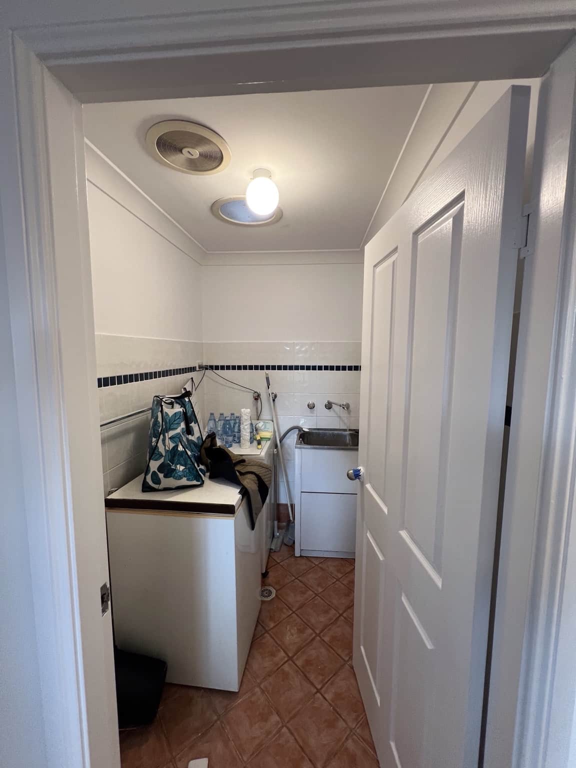 Laundry after interior painting with freshly finished walls, ceiling, door and trim in Merrylands