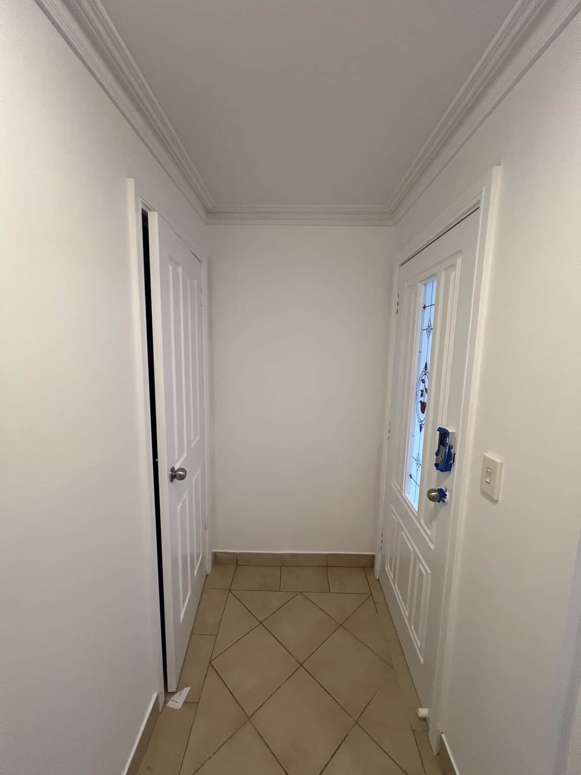 Entry hallway after interior painting with freshly finished doors and trim in Merrylands