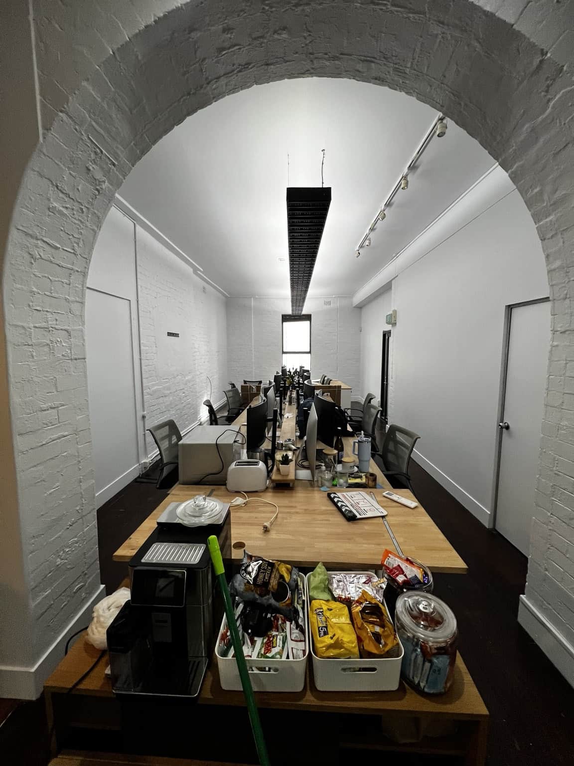 Freshly repainted Chippendale office interior with white walls and exposed brick texturePaint removal and brick wall preparation during commercial office painting in Chippendale