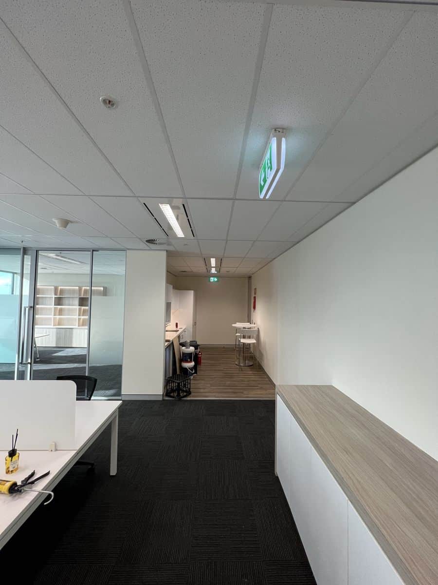 Completed Sydney CBD office repaint with clean white walls, hallway and built-in storage cabinetry