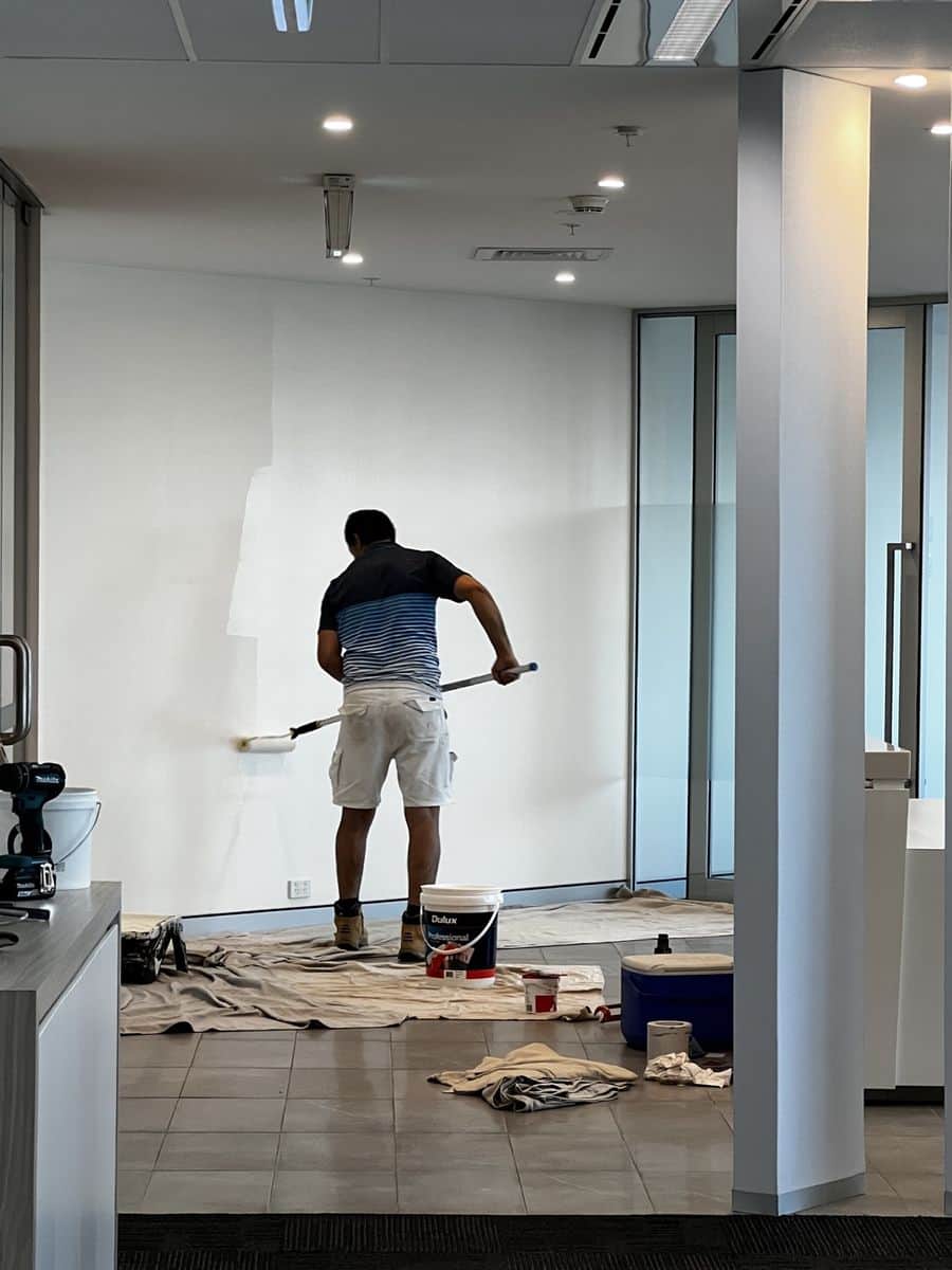 Freshly painted boardroom in Sydney CBD with white walls, large meeting table and harbour views