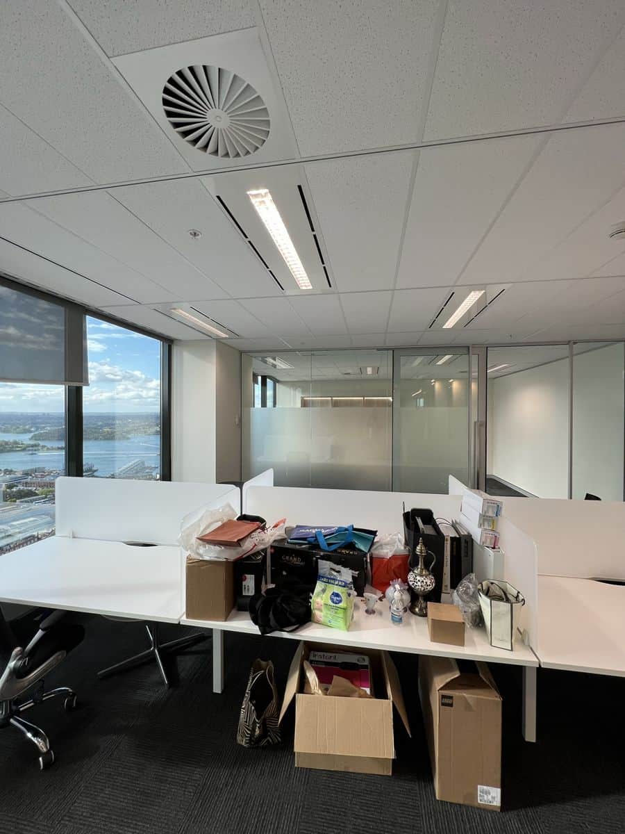 Modern meeting room in Sydney CBD after commercial painting with white walls, conference table and city views
