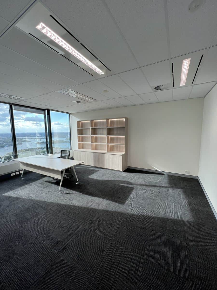 Professional painter applying Dulux paint to a commercial office wall in Sydney CBD